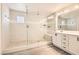 Luxurious bathroom featuring a glass-enclosed shower and double vanity at 5947 Wellington Peak Rd, Las Vegas, NV 89148