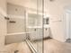 Modern bathroom with a glass shower enclosure, bench and dual vanity at 5947 Wellington Peak Rd, Las Vegas, NV 89148