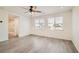 Bright bedroom with wood-look flooring and a view to the ensuite bath at 5947 Wellington Peak Rd, Las Vegas, NV 89148