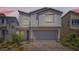 Charming two-story home featuring desert landscaping and a two-car garage at 5947 Wellington Peak Rd, Las Vegas, NV 89148