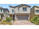 Charming two-story home featuring desert landscaping and a two-car garage at 5947 Wellington Peak Rd, Las Vegas, NV 89148