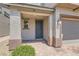 Charming front porch area with stone accents and a view of the garage at 5947 Wellington Peak Rd, Las Vegas, NV 89148