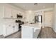 Modern kitchen with stainless steel appliances, white cabinets, and an island at 5947 Wellington Peak Rd, Las Vegas, NV 89148