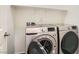 This laundry room contains a new Samsung washer and dryer set and overhead shelving at 5947 Wellington Peak Rd, Las Vegas, NV 89148