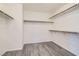 Spacious walk-in closet with wood-look flooring and ample storage space at 5947 Wellington Peak Rd, Las Vegas, NV 89148