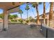 Backyard patio with a covered seating area surrounded by landscaping at 644 Wind Cave Ct, Henderson, NV 89012