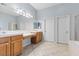 A large bright bathroom with a tiled floor, vanity, and walk in shower at 644 Wind Cave Ct, Henderson, NV 89012