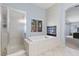 Luxurious bathroom with a soaking tub, walk-in shower, and fireplace at 644 Wind Cave Ct, Henderson, NV 89012