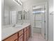 Bright bathroom featuring a double sink and a shower-tub at 644 Wind Cave Ct, Henderson, NV 89012