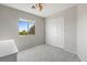 Bright bedroom with carpet, a large window, and closet with sliding doors at 644 Wind Cave Ct, Henderson, NV 89012