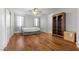 Cozy bedroom featuring hardwood floors, a comfortable bed, and ample natural light at 644 Wind Cave Ct, Henderson, NV 89012