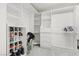 A walk-in closet boasts custom shelving, drawers, and ample storage space for clothes and accessories at 644 Wind Cave Ct, Henderson, NV 89012