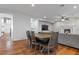 Dining area with hardwood floors, dining table, chairs, and fireplace in the background at 644 Wind Cave Ct, Henderson, NV 89012