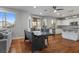 Open dining area with hardwood floors, a rustic table, and a view into the kitchen and backyard at 644 Wind Cave Ct, Henderson, NV 89012