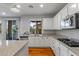 Bright and modern kitchen with granite countertops and stainless steel microwave at 644 Wind Cave Ct, Henderson, NV 89012