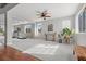 Sunlit living room with neutral carpet, arched windows, and a dedicated workout area at 644 Wind Cave Ct, Henderson, NV 89012