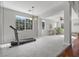 Spacious living room area with ample natural light and a treadmill for exercise at 644 Wind Cave Ct, Henderson, NV 89012