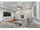 Inviting living room with a fireplace, hardwood floors, and comfortable gray seating at 644 Wind Cave Ct, Henderson, NV 89012