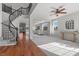 Open floor plan featuring a staircase, hardwood flooring, and comfortable seating area at 644 Wind Cave Ct, Henderson, NV 89012