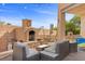 Outdoor living space with a fireplace and comfortable seating at 644 Wind Cave Ct, Henderson, NV 89012