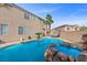 Backyard featuring a private pool with stunning rock waterfall, offering a serene outdoor living and entertaining space at 644 Wind Cave Ct, Henderson, NV 89012