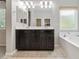 Bathroom featuring double sinks, soaking tub, and tiled floor at 7345 Chesapeake Cove St, Las Vegas, NV 89166