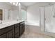 Bathroom featuring double sinks, soaking tub, and glass shower enclosure at 7345 Chesapeake Cove St, Las Vegas, NV 89166