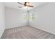 Bedroom with neutral carpet, two windows, and a ceiling fan at 7345 Chesapeake Cove St, Las Vegas, NV 89166