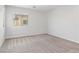 Bright, empty bedroom with carpet and ample natural light through a window at 7345 Chesapeake Cove St, Las Vegas, NV 89166