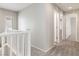 Hallway with neutral carpet, white walls and baseboards, and multiple doorways at 7345 Chesapeake Cove St, Las Vegas, NV 89166