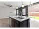 Open concept kitchen showcases granite countertops, stainless steel appliances, and backyard views at 7345 Chesapeake Cove St, Las Vegas, NV 89166