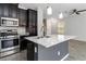 Modern kitchen boasts stainless steel appliances, granite countertops, and dark wood cabinetry at 7345 Chesapeake Cove St, Las Vegas, NV 89166