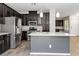 Modern kitchen with stainless steel appliances, granite countertops, and a center island at 7345 Chesapeake Cove St, Las Vegas, NV 89166