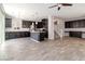 Open concept living area with wood flooring and island flowing into a modern kitchen at 7345 Chesapeake Cove St, Las Vegas, NV 89166
