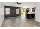 Open concept living area with wood flooring, modern lighting, and sliding doors to the backyard at 7345 Chesapeake Cove St, Las Vegas, NV 89166
