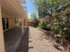 Covered patio with rock landscaping and shrubbery at 8708 Gateway Glen Dr, Las Vegas, NV 89178