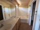 Bright bathroom features a double sink vanity and a shower-tub combo at 8708 Gateway Glen Dr, Las Vegas, NV 89178