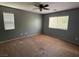 Spacious carpeted bedroom with ample natural light from the two windows and ceiling fan at 8708 Gateway Glen Dr, Las Vegas, NV 89178
