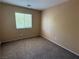 Neutral bedroom features a carpeted floor, window with blinds, and natural light at 8708 Gateway Glen Dr, Las Vegas, NV 89178
