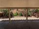 Covered patio with gravel landscaping and retaining wall provides a shady spot for outdoor relaxation at 8708 Gateway Glen Dr, Las Vegas, NV 89178