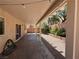 A covered patio with string lights and a gravel border for landscaping at 8708 Gateway Glen Dr, Las Vegas, NV 89178