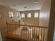 Upper landing featuring wooden railings and multiple windows providing natural light at 8708 Gateway Glen Dr, Las Vegas, NV 89178