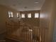 Upstairs landing with wooden railings and well-lit by several windows at 8708 Gateway Glen Dr, Las Vegas, NV 89178