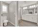 Bathroom featuring a double vanity, white cabinets, and glass enclosed shower at 872 Pointe Arbor St, Henderson, NV 89011