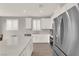 Modern kitchen boasting stainless steel appliances, white cabinets, and a sleek countertop at 872 Pointe Arbor St, Henderson, NV 89011