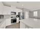 Modern kitchen with white cabinets, stainless steel appliances, and a center island at 872 Pointe Arbor St, Henderson, NV 89011