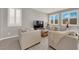Cozy living room features neutral decor and bright, shuttered windows at 872 Pointe Arbor St, Henderson, NV 89011