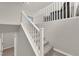 Carpeted staircase with white railing leading to the second floor at 872 Pointe Arbor St, Henderson, NV 89011