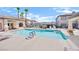 Community pool area surrounded by lounge chairs and lush landscaping at 8725 W Flamingo Rd # 110, Las Vegas, NV 89147