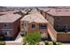 Aerial view showcasing the home's layout, including a balcony and desert landscaping with privacy wall at 9032 Retro Ct, Las Vegas, NV 89149